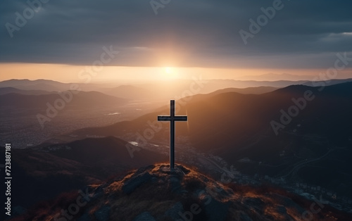 Cross on the rock with dramatic sunset sky background.
