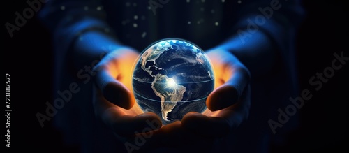 Businessman holding Earth planet in his hands on dark background 