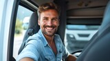 Cheerful truck driver smiling confidently in the cab of his truck, representing the face of reliable transportation services