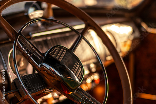 Detail of the steering wheel and dashboard of a classic car. © WeźTylkoSpójrz