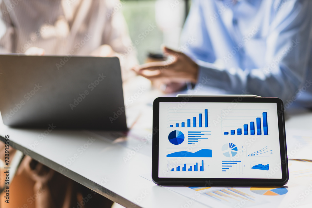 Business growth graphs and charts discussion meeting on modern digital tablets and financial planning for investments. Strategy analysis and business planning. Business growth graphs and charts discussion meeting on modern digital tablets and financial planning for investments. Strategy analysis and business planning.