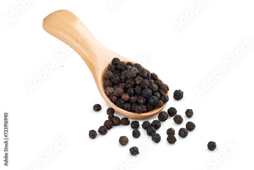 Wooden spoon with black pepper and peppercorns isolated on a white background. Spices for cooking, close up