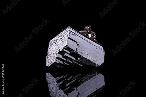 schorl (black tourmaline) photography isolated on black background. From Erongo Complex, Namibia.
macro detail close-up rough raw unpolished semi-precious gemstone.
 photo