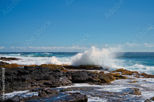 waves crashing on rocks in hawaii