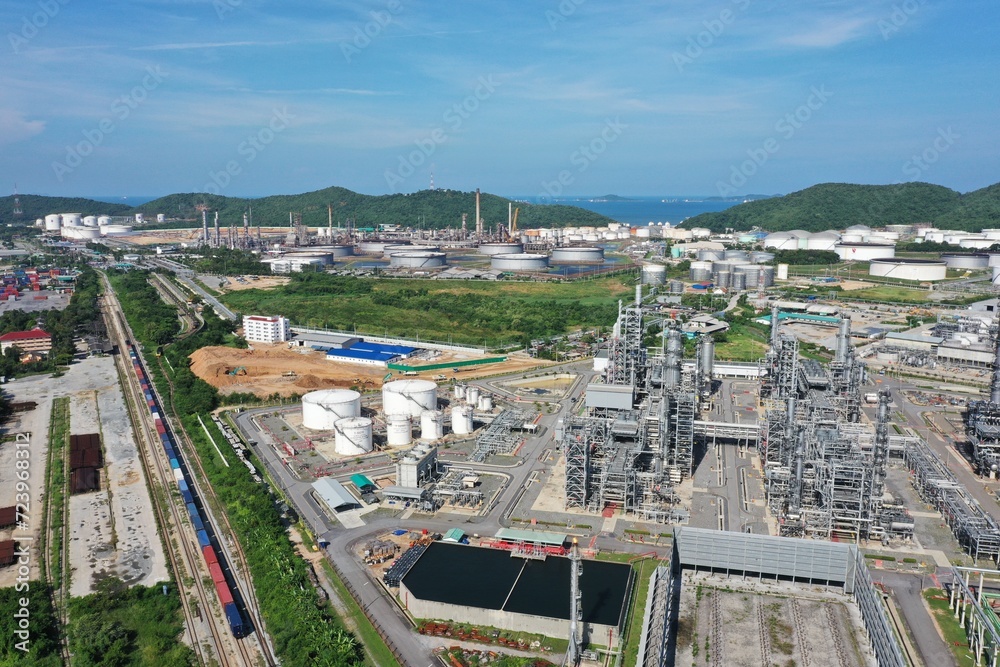 Aerial view of oil refinery or chemical factory and power plant with many storage tanks and pipelines. Business and petrochemical plants, oil storage tanks and for energy and steel pipes.