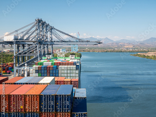 Two container ships has loading operations with few gantry cranes in Lazaro Cardenas Container Terminal during the the day time.
