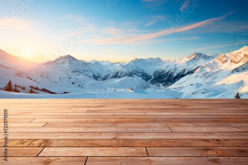 Empty wooden floor against the backdrop of Snowy Mountain with sunset 