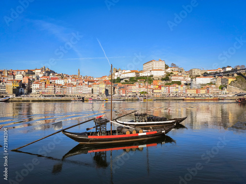 Navegando o Douro: Um barco Rabelo na ribeira de Vila Nova de Gaia, com a antiga cidade como pano de fundo photo