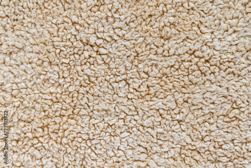 Beige soft background of plush fabric.