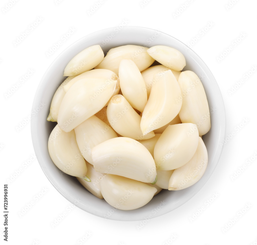 Peeled cloves of fresh garlic in bowl isolated on white, top view