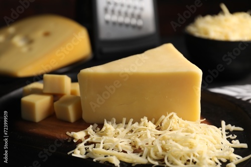 Grated and cut cheese on table, closeup