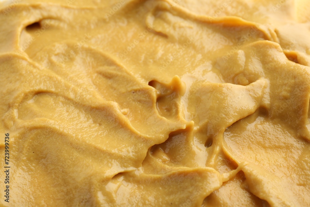 Fresh tasty mustard sauce as background, closeup Fresh tasty mustard sauce as background, closeup