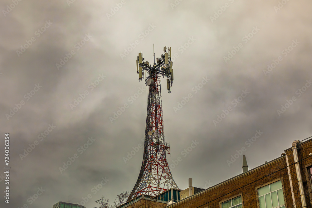 A microwave and cellphone communications tower atop an apartment building _ in downtown Toronto.