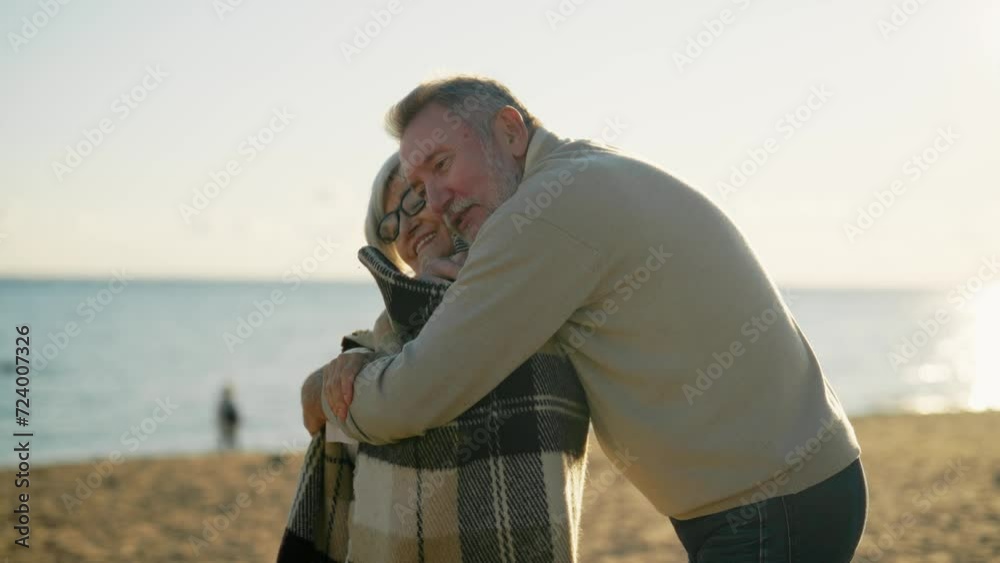 Happy smiling senior man hugging woman on sea beach at sunset in evening. Elderly couple family on important date cuddling embracing talking. Lifelong relationships and happy marriage concept. Happy smiling senior man hugging woman on sea beach at sunset in evening. Elderly couple family on important date cuddling embracing talking. Lifelong relationships and happy marriage concept.