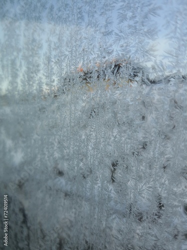 Ice crystals formations on glass car window.