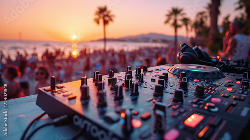 Beach party festival with dj mixing, Close up portrait of dj mixer table with beautiful evening sunset at tropical beach photo