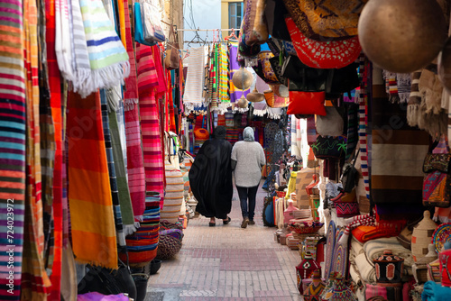 Two women walking around the souk in Essaouira, Morocco