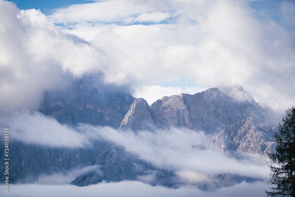 Dolomites Mountains covered in clouds in autumn season. Italy