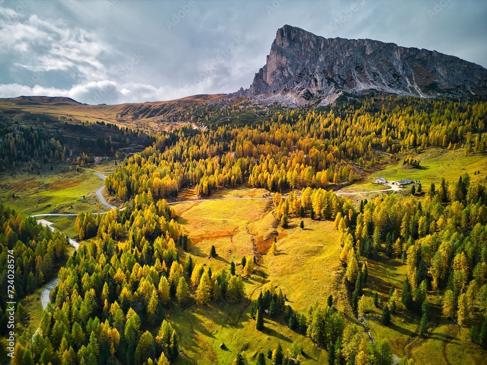 Aerial drone view of Dolomites Mountains in autumn season with forest. Italy
