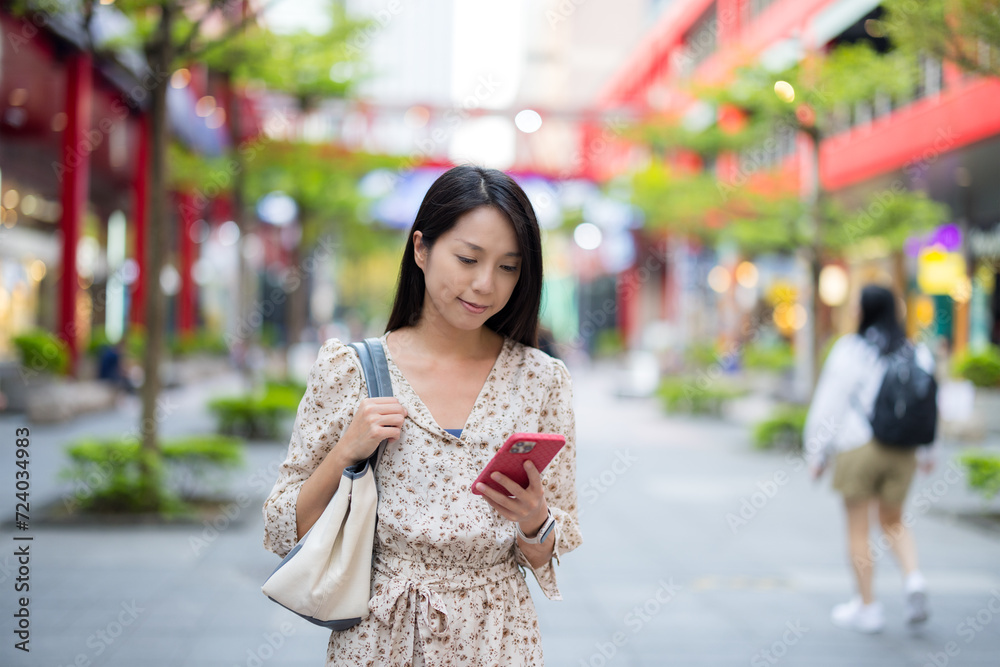 Woman use of mobile phone in the city Woman use of mobile phone in the city
