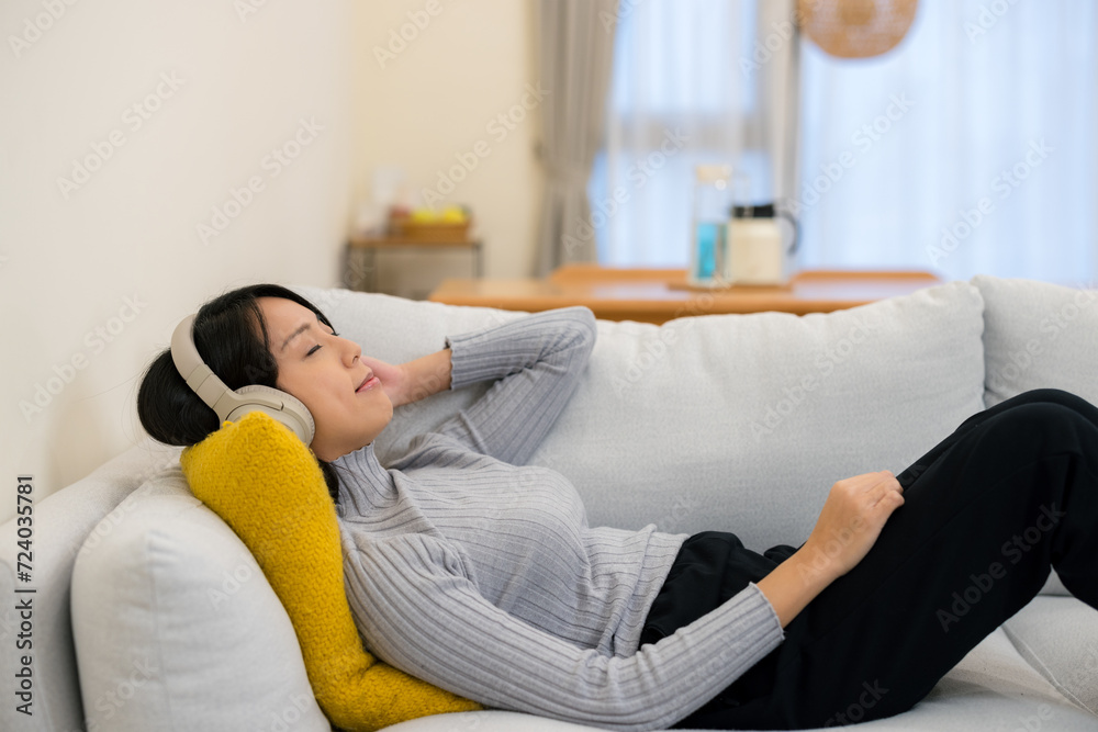 Woman lying down and enjoy the music on headphone Woman lying down and enjoy the music on headphone