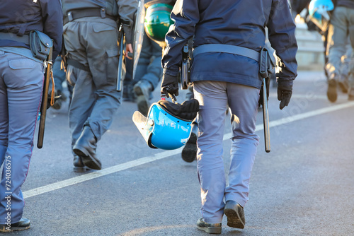 policemen in uniform with riot gear during the protest demonstration with helmets and shields photo