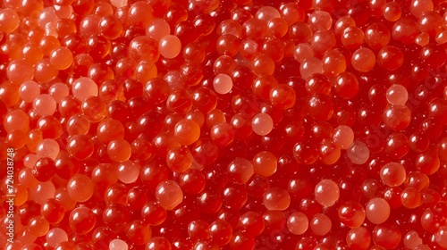 An abstract background of red tobiko fish roe. Flying fish roe in high quality raw texture. Tobiko with notes of sweetness and an especially crunchy texture. photo