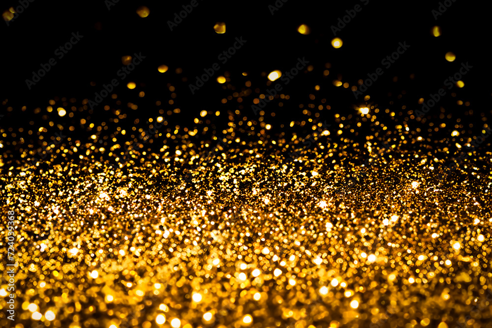 Gold glitter on black background.