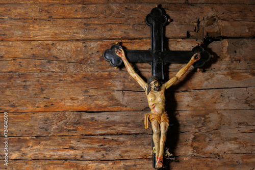 Divine Serenity: Crucifix with Jesus against Antique Church Wooden Wall