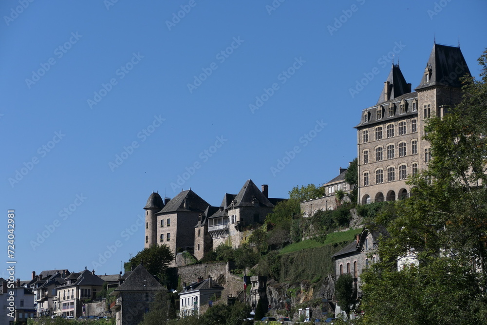 Uzerche, a picturesque French city, graces the hillside with its timeless charm during the summer. The city view reveals a tapestry of old buildings adorned with architectural elegance.
