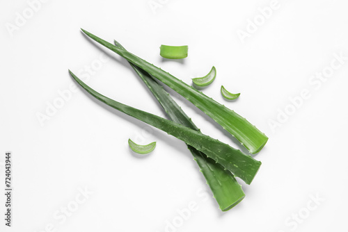 Cut aloe vera leaves on white background, flat lay