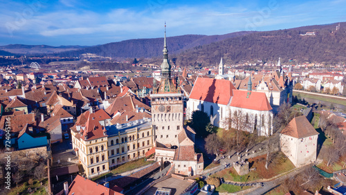 Birds eye view over Sighisoara city. Aerial photography of medieval city of Sighisoara from Romania, taken from a drone with the Clock Tower in the front. 