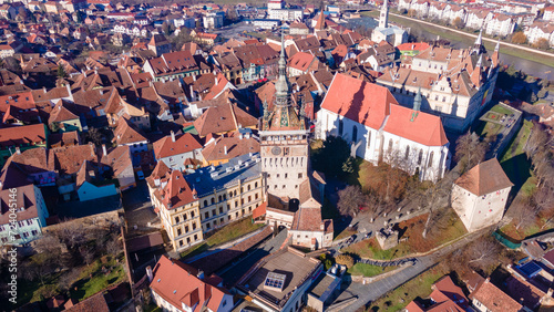 Birds eye view over Sighisoara city. Aerial photography of medieval city of Sighisoara from Romania, taken from a drone with the Clock Tower in the front. 