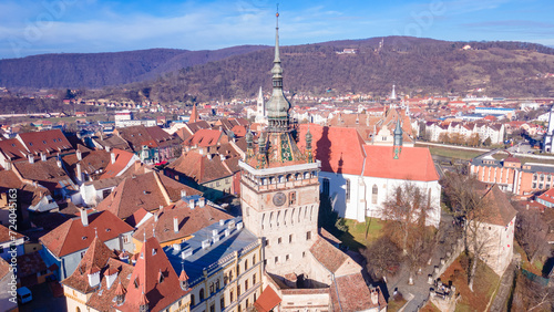 Birds eye view over Sighisoara city. Aerial photography of medieval city of Sighisoara from Romania, taken from a drone with the Clock Tower in the front. 