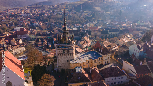 Birds eye view over Sighisoara city. Aerial photography of medieval city of Sighisoara from Romania, taken from a drone with the Clock Tower in the front. 
