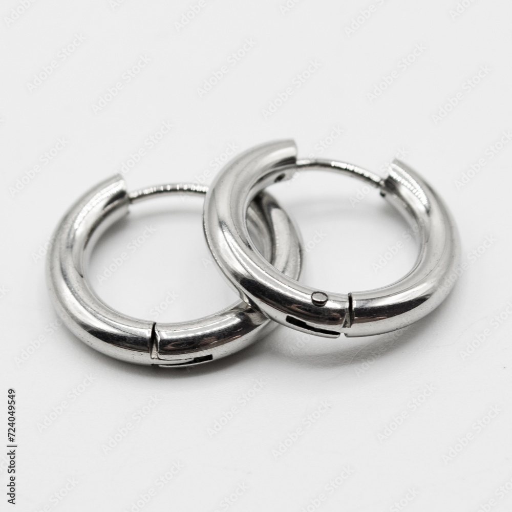 Fake hard earring. White silver ear ring. Imitation jewelry. Accessory for rockers, rap, hip-hop, bikers, emo. Creation of a scenic view. Pirate style. Fake hard earring. White silver ear ring. Imitation jewelry. Accessory for rockers, rap, hip-hop, bikers, emo. Creation of a scenic view. Pirate style.