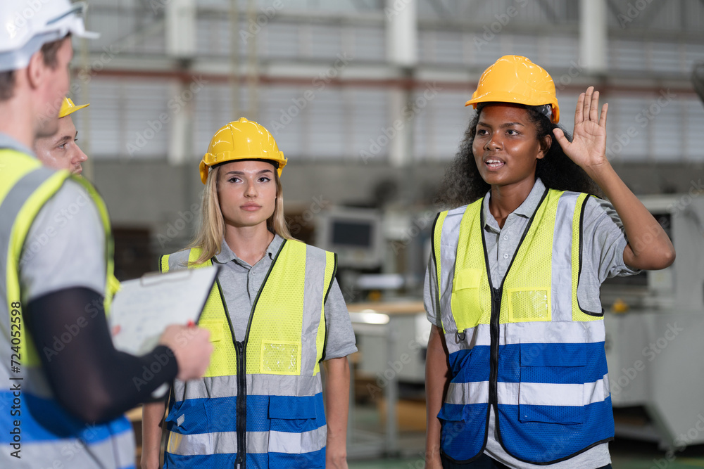 Portrait African American businesswoman hand up with team working with machine at factory Portrait African American businesswoman hand up with team working with machine at factory
