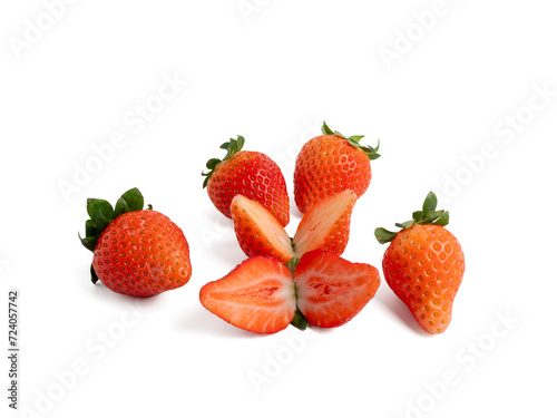 Fototapeta Naklejka Na Ścianę i Meble -  Strawberries cut in half and whole on a white background. Strawberries close up.