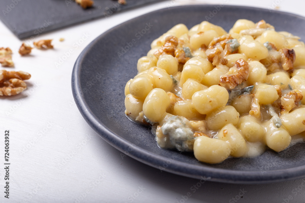 Gnocchi with Gorgonzola and walnuts. Typical Italian food. Gnocchi with Gorgonzola and walnuts. Typical Italian food.