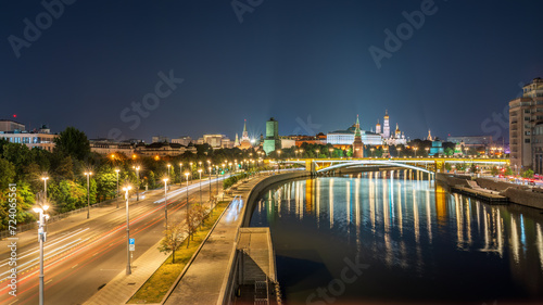 Illuminated Moscow Kremlin and Bolshoy Kamenny Bridge at summer night. View from the Patriarshy pedestrian Bridge photo