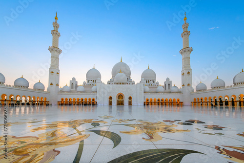 Interior courtyard of the Sheikh Zayed Grand Mosque, the largest mosque in the UAE, illuminated at twilight in Abu Dhabi, United Arab Emirates. photo