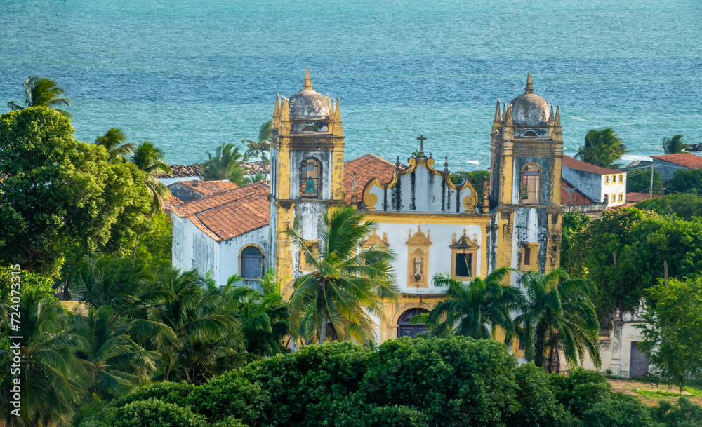 Ancient coastal church surrounded by lush tropical forest in the old colonial town of Olinda, Recife, Brazil. A UNESCO World Heritage site
