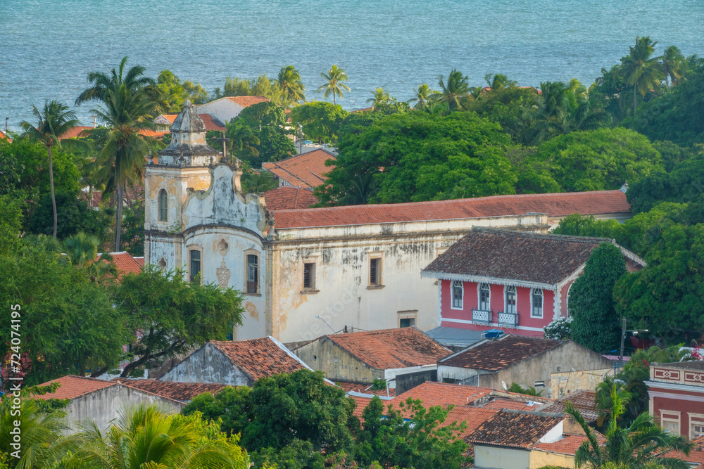 Ancient coastal church surrounded by lush tropical forest in the old colonial town of Olinda, Recife, Brazil. A UNESCO World Heritage site