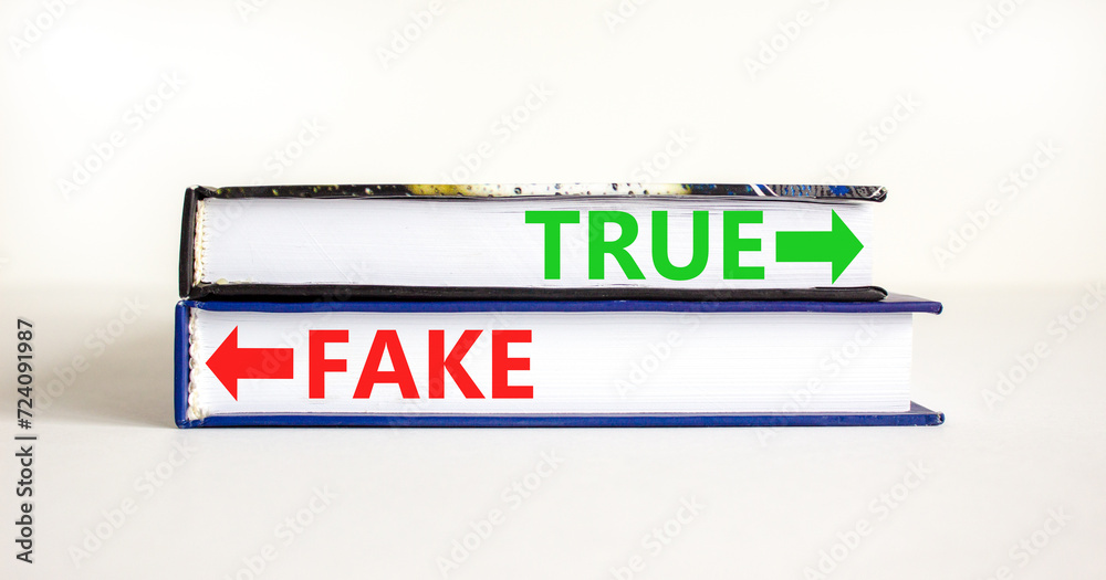 True or fake symbol. Concept word True or Fake on beautiful books. Beautiful white table white background. Business and true or fake concept. Copy space.
