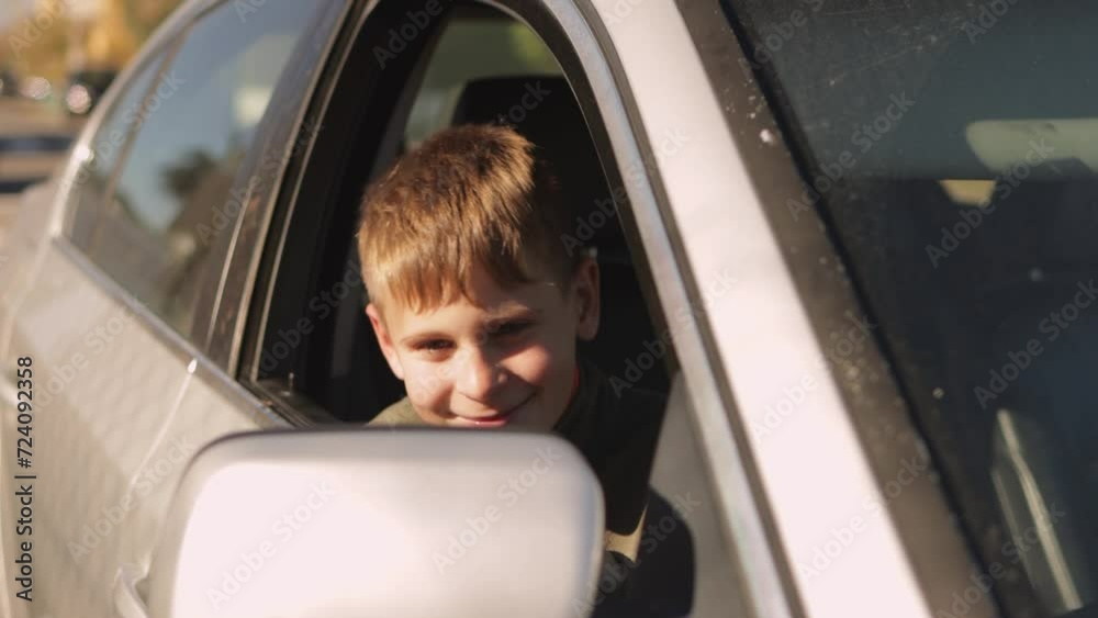 happy teenage boy sits in the passenger seat in a car and cheerfully grimaces at the camera, happy teenage boy sits in the passenger seat in a car and cheerfully grimaces at the camera,