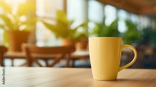 Light Yellow Coffee Cup on a wooden Table. Blurred Interior Background