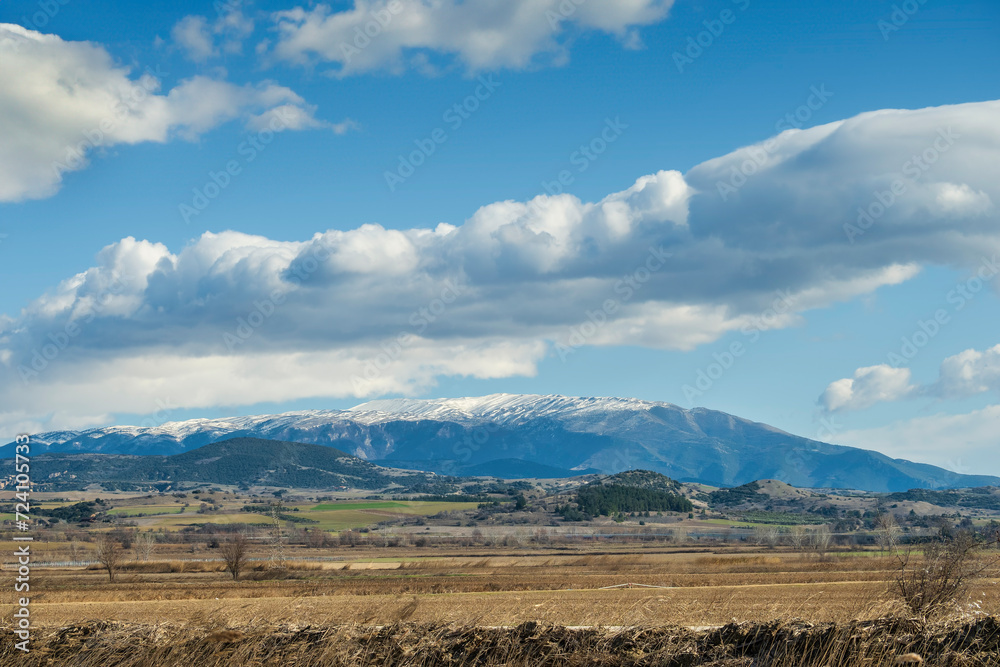 white clouds over snowy mountain on sunny winter day