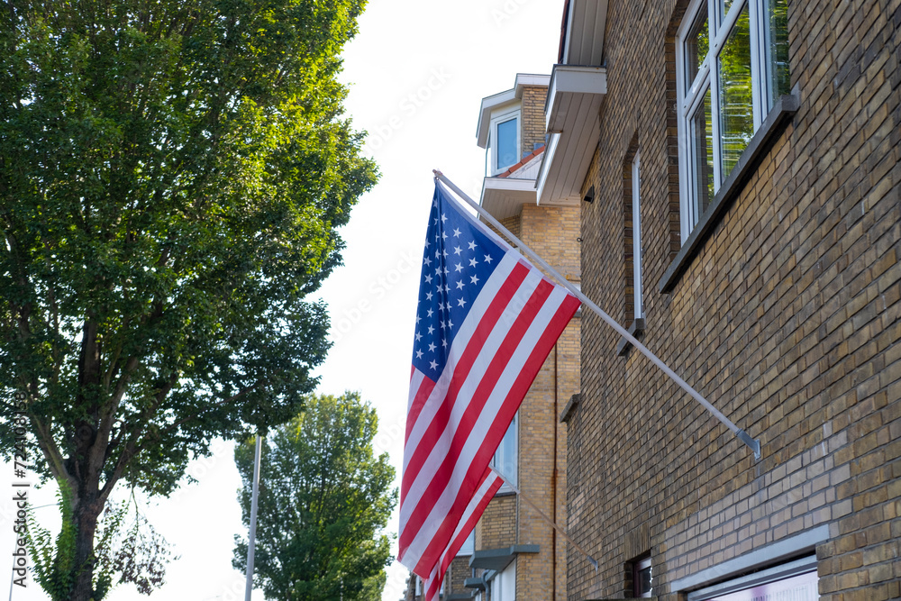 national flag of USA flutters on silk cloth against sky, 4th of July independence day concept, global trading on stock exchange, business and country's budget