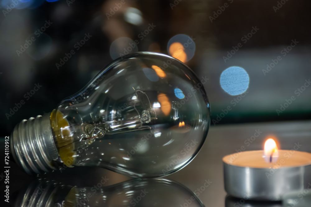 A candle burns near an incandescent light bulb, the price of electricity A candle burns near an incandescent light bulb, the price of electricity