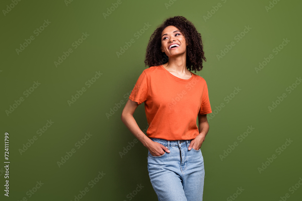 Photo of cheerful sweet lady dressed orange t-shirt looking empty space isolated khaki color background Photo of cheerful sweet lady dressed orange t-shirt looking empty space isolated khaki color background